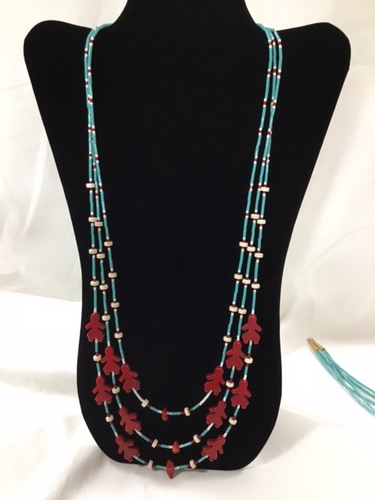 Three strand necklace is dedicated to Indigenous women everywhere, it is framed in turquoise bugle beads and highlighted by white bone beads as well as size 9 red and white glass beads.  The  shortest strand is 30